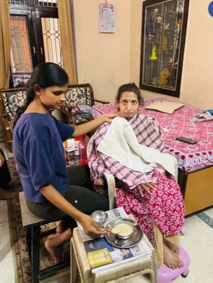 Caregiver providing daily support to an elderly patient at home