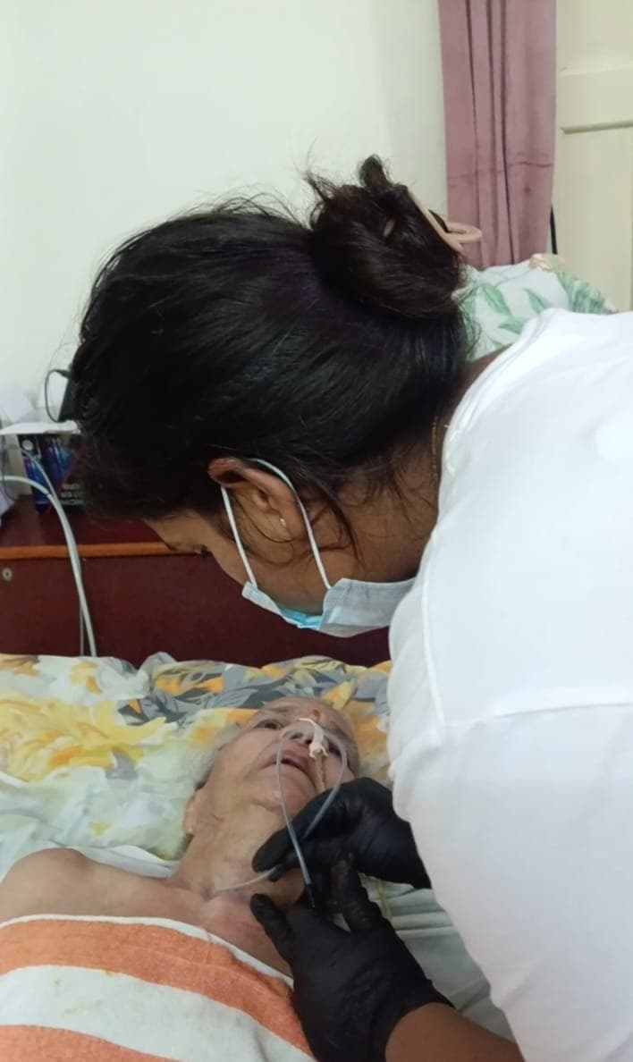 Nurse providing attentive bedside care to a patient